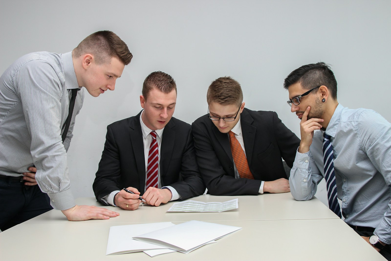 ESG Strategy and Reporting | Land Sterling Business team members reviewing policy documents during a strategy discussion in an open-plan office