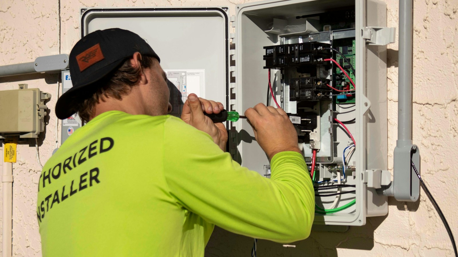 ESG and Sustainability Advisory for Real Estate | Land Sterling | Land Sterling Engineer in high-visibility workwear servicing an electrical energy panel