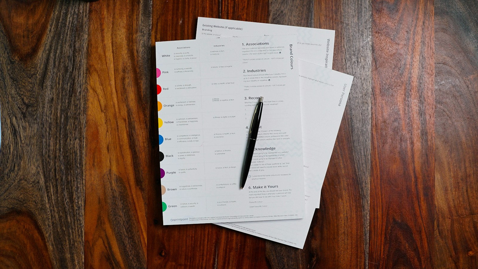 Stack of paperwork and documents on a wooden table awaiting review
