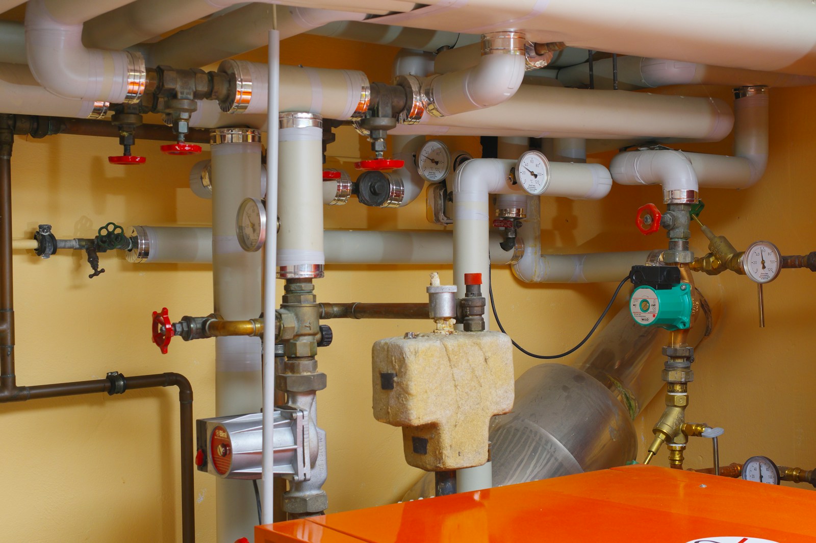 Industrial plant room with pipes, valves and machinery