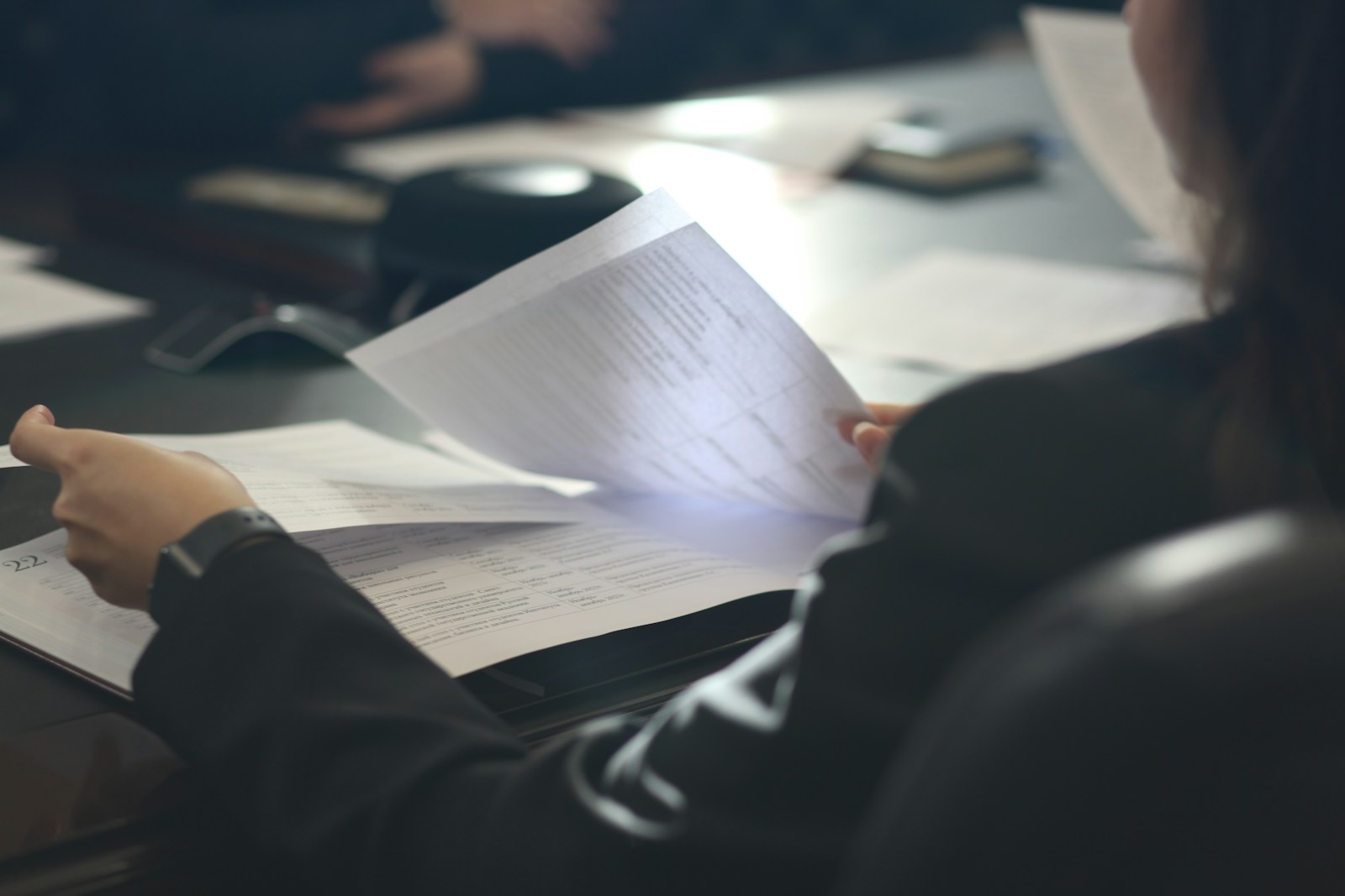 ESG and Sustainability Advisory for Real Estate | Land Sterling | Land Sterling Analyst reviewing reporting documents at an office desk