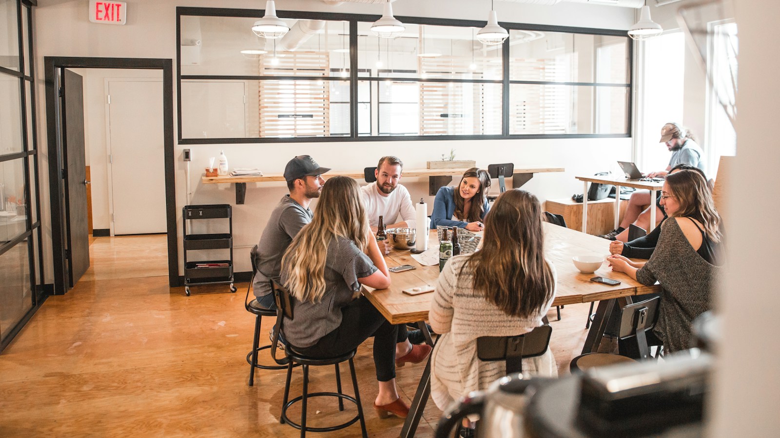 Collaborative meeting around a table with documents and folders during a review