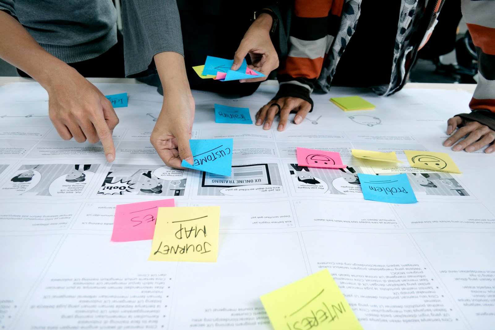 Colleagues discussing a portfolio map and asset planning across a table