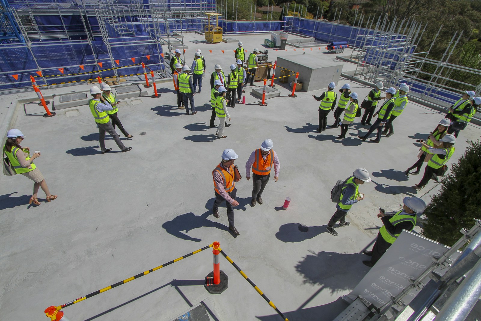 Construction workers attending a site safety briefing wearing protective equipment
