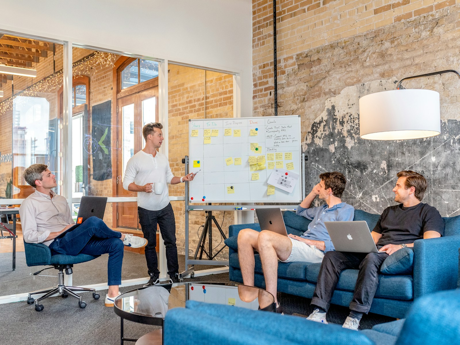 ESG Strategy and Reporting | Land Sterling Small team planning milestones together while one colleague presents ideas at a whiteboard