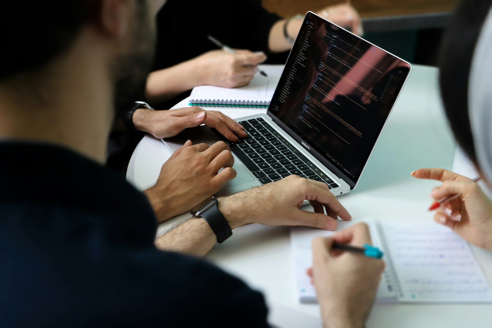 Team reviewing data together around a laptop during a meeting