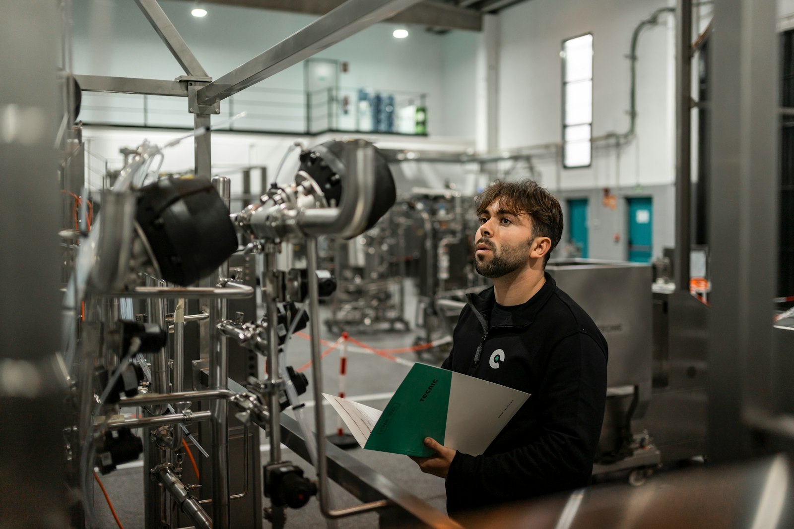 Building Decarbonisation | Land Sterling Technician reviewing installed mechanical installations