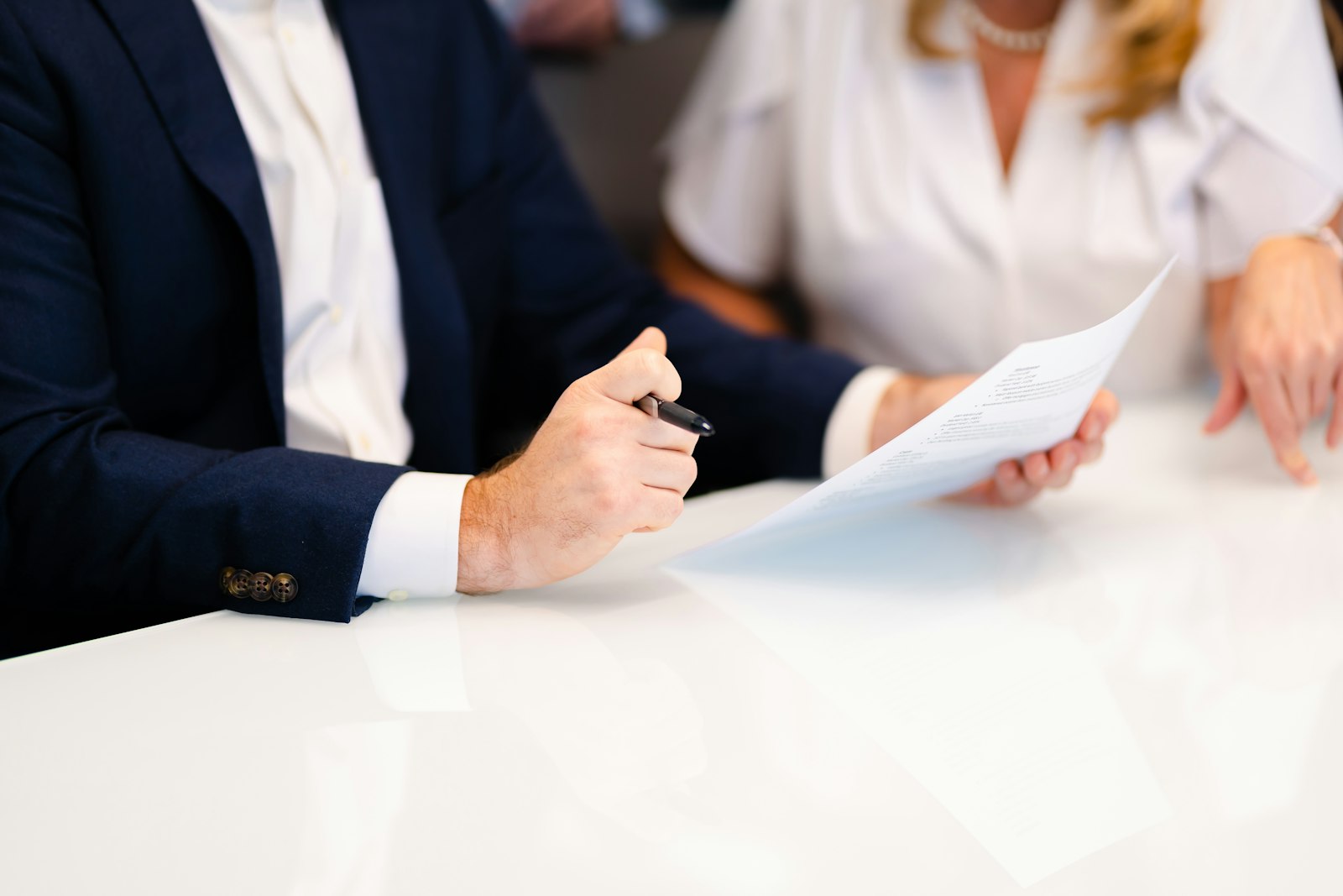 Colleagues reviewing policy documents at a meeting table